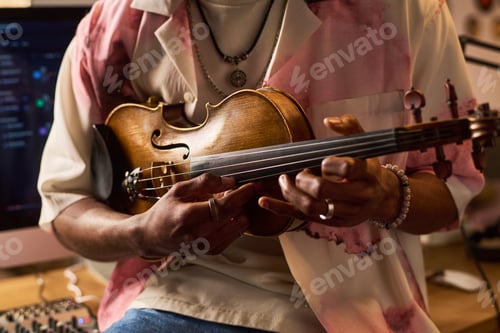 Preview: Black Young Musician Holding Violin for Home Recording Session