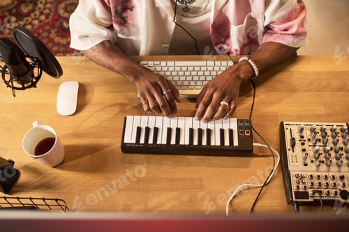 Preview: Black Man Producing Music on Midi Keyboard for Home Studio Content
