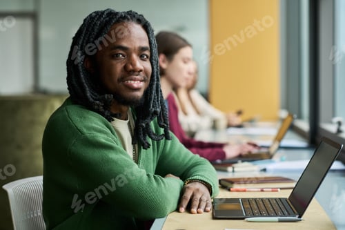 Preview: Portrait of Black Man Studying with Laptop in Modern Classroom