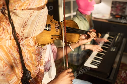 Preview: Black Man Playing Violin during Music Rehearsal with Keyboard