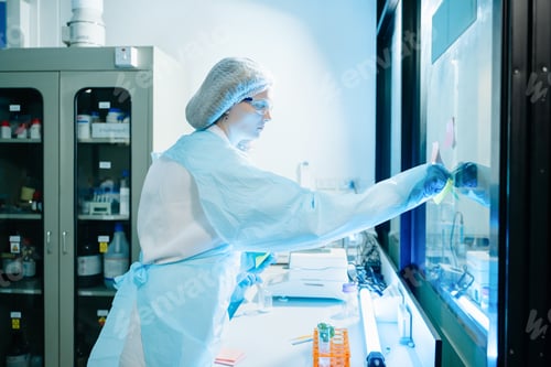 Preview: Caucasian woman researcher analyzing liquid samples with professional equipment in clean medical lab