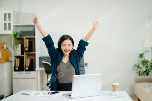 Preview: Asian business woman are delighted and happy with the work they do on their tablet, laptop and takin