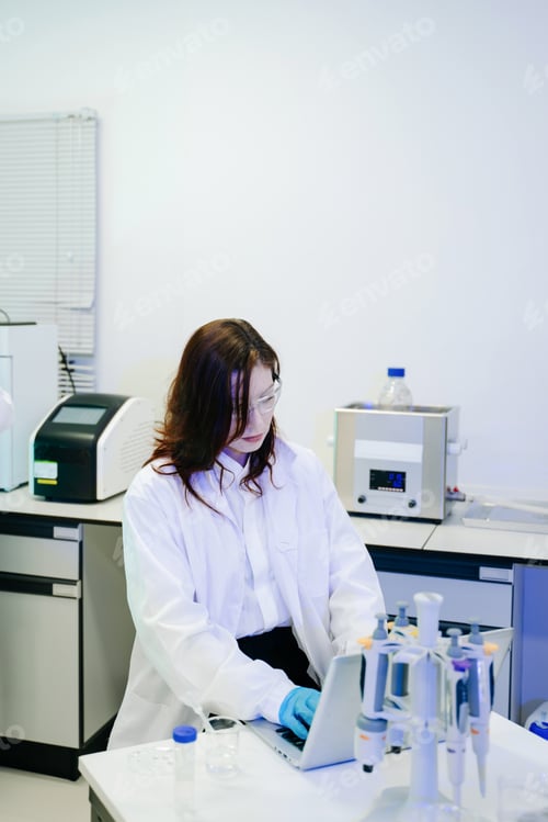 Preview: Young scientists conducting research investigations in a medical laboratory, a researcher in the for