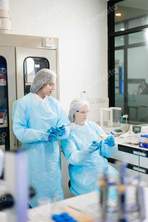 Preview: Two Scientists Using Laptop in Laboratory Biotechnology Research, Data Analysis & Healthcare Innovat