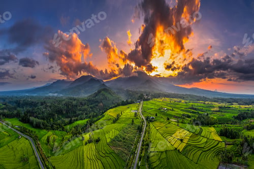 Preview: Beautiful morning view in Indonesia, panoramic landscape of rice fields with mountain ranges and cle