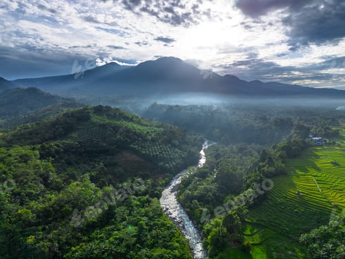 Preview: Beautiful morning view in Indonesia, panoramic landscape of rice fields with mountain ranges and cle