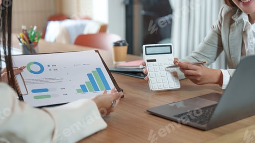 Preview: Asian business women calculating and analyzing financial data