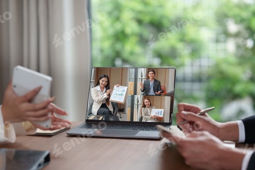 Preview: Asian business team in virtual meeting with multiple presenters on laptop