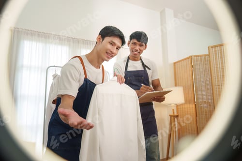 Preview: Asian men presenting white shirt for online small business e-commerce