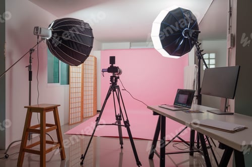 Preview: Empty photography studio setup with pink backdrop and lights for behind the scenes concept