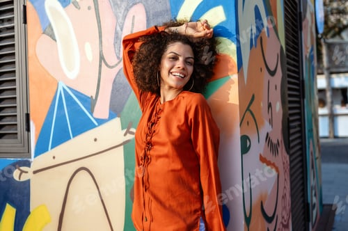 Preview: Woman radiates pure love of life, smiling against a vibrant, expressive urban backdrop