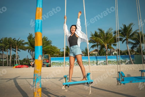 Preview: Mindful woman connecting with nature and feeling the breeze during a peaceful morning on the beach