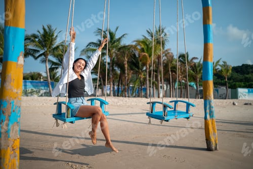 Preview: Trendy young traveler enjoying sunny weather and coastal breeze on a luxury tropical island resort