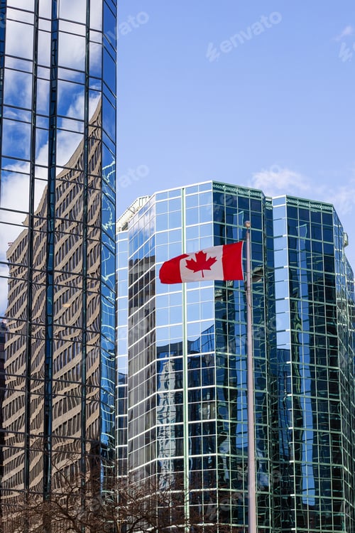 Preview: Canadian flag waving in front of glass buildings