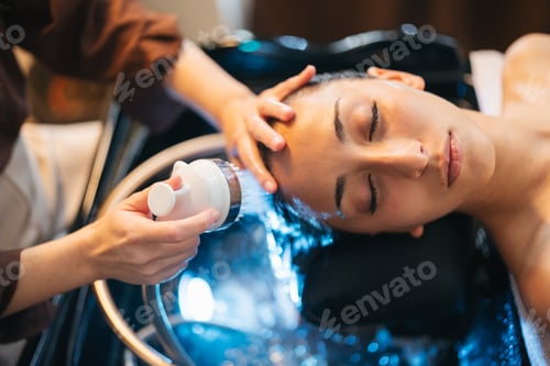Preview: Close up of hair washing with water flow in salon