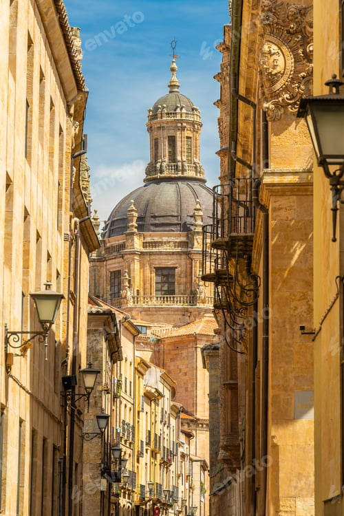 Preview: Narrow historic street in Salamanca leading to the dome of La Clerecia church