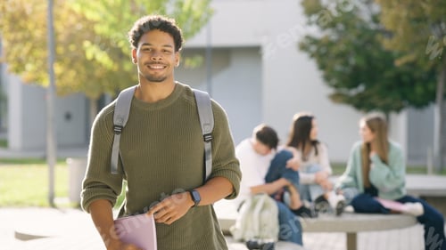 Preview: Young student smiling on university campus