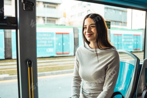 Preview: Woman commuting by bus smiling looking out window
