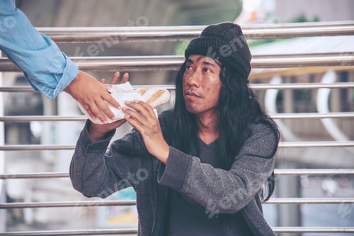 Preview: Woman helping hands to homeless people poverty beggar man holding hands asking for money job and hop