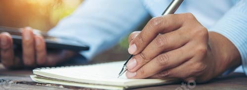 Preview: Banner Woman hands writing empty notebook planing meeting agenda on wooden table. Banner Close up wo