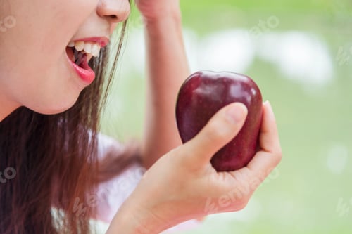 Preview: Young asian woman eating red Apple Healthy. Girl workout holding organic apple fruit healthy lifesty