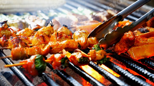 Preview: BBQ Barbecue grilled meat stick on fire flame with hot charcoal cooking outside. Beef grilling picni