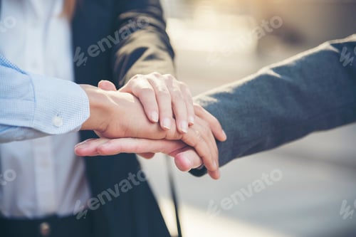 Preview: Group of diversity people with success partnership fist bump of hands together to show power and uni