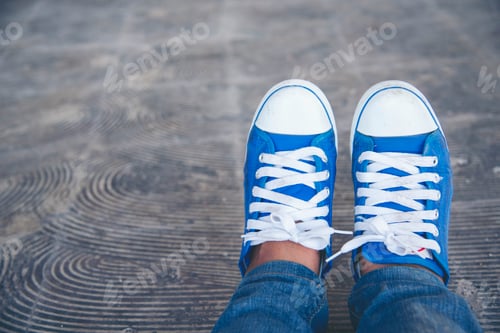 Preview: Sport sneakers footwear young woman knelt down do up shoelaces. Ready running shoes in sport exercis