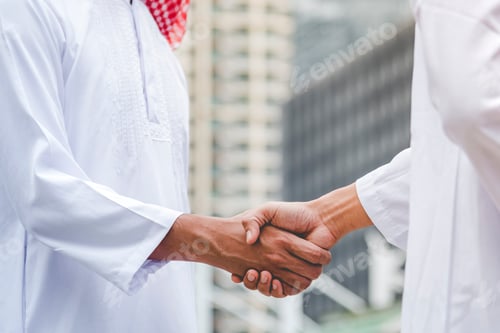 Preview: Islamic businessman shake hands together dealing success business in modern muslim UAE city. Arab ma