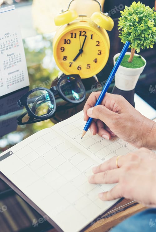 Preview: Vertical Horizon Woman hands writing empty notebook planing meeting agenda wooden table. Close up wo