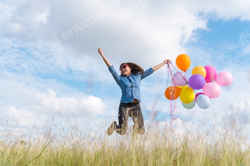 Preview: Woman holding balloons running on green meadow white cloud and blue sky with happiness Cheerful and