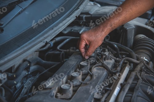 Preview: Close up Mechanic man hands repairing car auto repair shop uses jack change tyre. Man hands fixing S