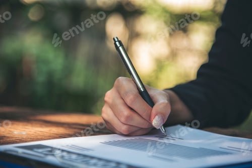 Preview: Woman hands writing empty notebook planing meeting agenda on wooden table. Close up women hands usin