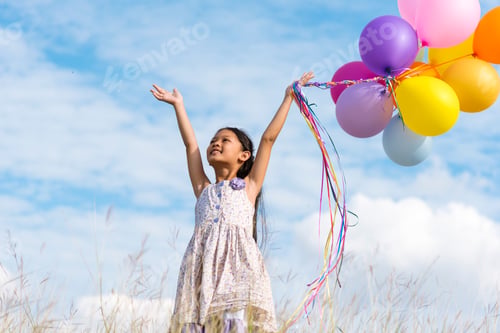 Preview: Cheerful cute girl holding balloons running on green meadow white cloud and blue sky with happiness.