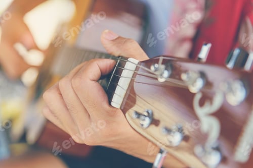 Preview: Handsome men playing acoustic guitar outdoor in green park. young man playing acoustic guitar music
