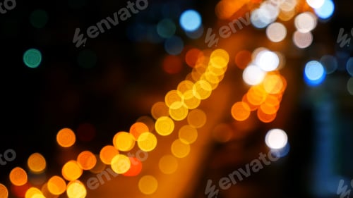 Preview: Blurred background night city bokeh car drive on road in nightlife. Light line traffic jam in black