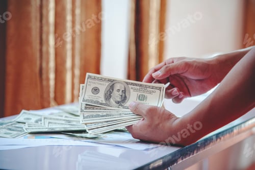 Preview: Hand holding loan money dollar bank note give financial payment. Man hands showing spread 100 dollar