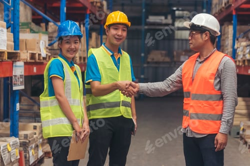 Preview: Asian Engineer man, women hands partnership. Coworker colleague logistics Warehouse teams handshake.