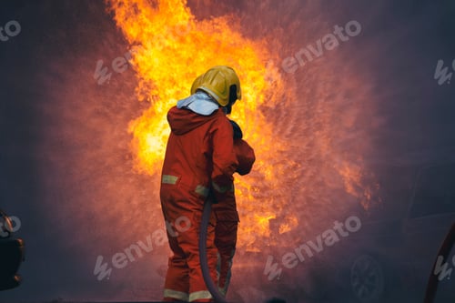 Preview: Firefighter fighting with flame using fire hose chemical water foam spray engine. Fireman wear hard