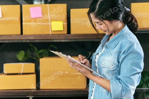 Preview: Woman checking stock goods supply delivery package shipping use document checklist. Asian woman star