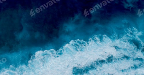Preview: Turquoise ocean sea water white wave splashing deep blue sea. Bird eye view monster wave splash on r