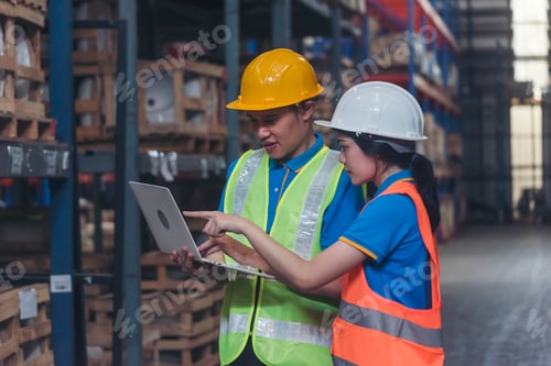 Preview: Warehouse management team using computer laptop check stock inventory. Asian men women worker use so