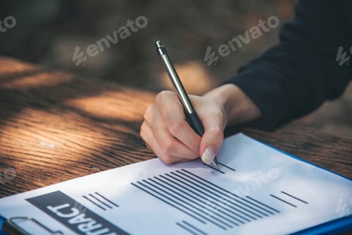 Preview: Hands Writing Empty Notebook Planing Meeting Agenda on Wooden Table