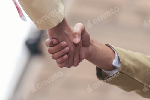 Preview: Arab Businessman shaking hands together. Teamwork business partner wear Muslim dress Shake Hands wit