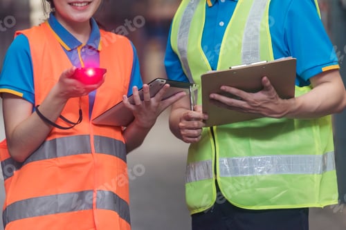 Preview: Asian men women worker use bar code scaner scan goods shelf writing checklist on clipboard. Warehous