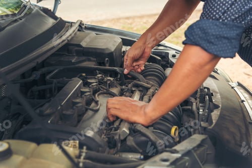 Preview: Close up Car Mechanic man hands repairing car auto repair shop. Man hands fixing machinery vehicle m