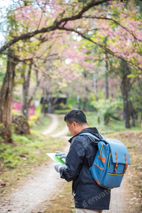 Preview: Vertical image Asian man use professional digital camera take a photo. Smiling male photographer loo