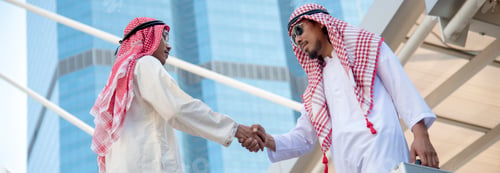 Preview: Banner Arab Businessman shaking hands together. Teamwork business partner wear Muslim dress Shake Ha