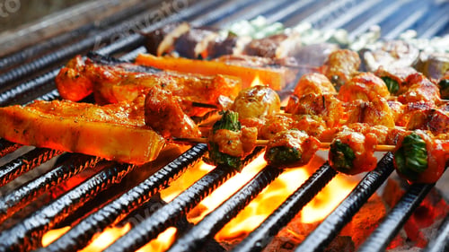 Preview: BBQ Barbecue grilled meat stick on fire flame with hot charcoal cooking outside. Beef grilling picni