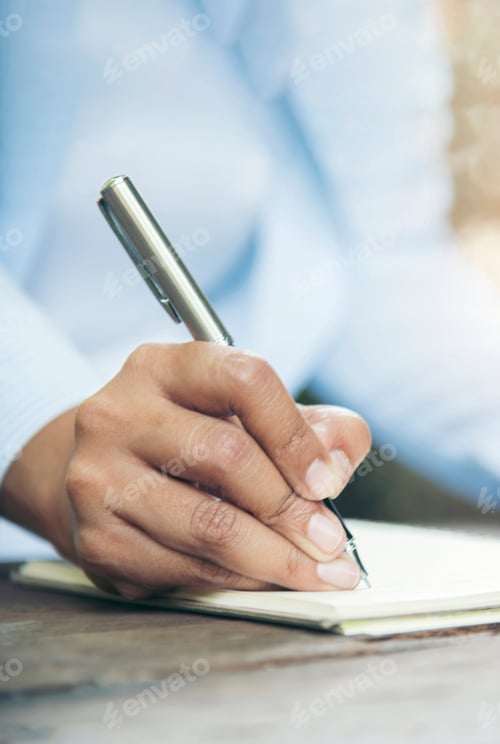 Preview: Vertical Horizon Woman hands writing empty notebook planing meeting agenda wooden table. Close up wo
